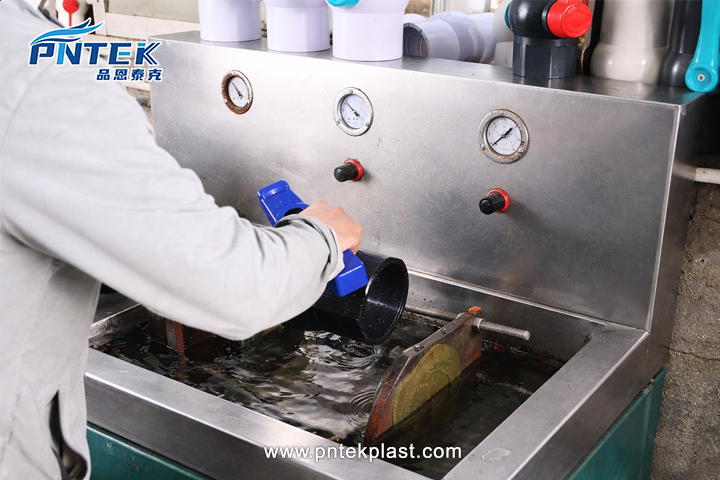 100% Pressure Testing for Valve Reliability A quality control technician conducting a pressure test on a PVC ball valve