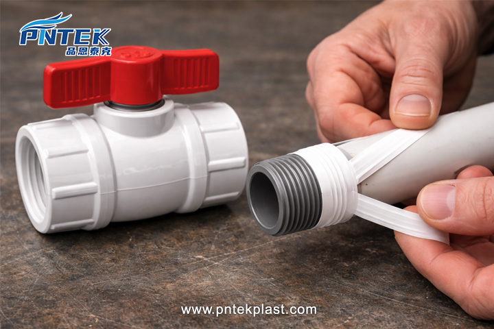 Applying Sealant to NPT Threads An installer wrapping PTFE tape around the male NPT threads of a pipe before screwing it into a ball valve
