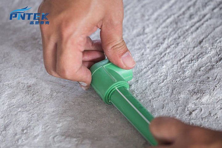 A collection of green PPR fittings including elbows, tees, and sockets