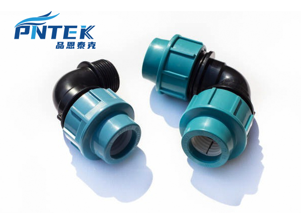 An assortment of Pntek PP compression fittings like elbows, tees, and couplers