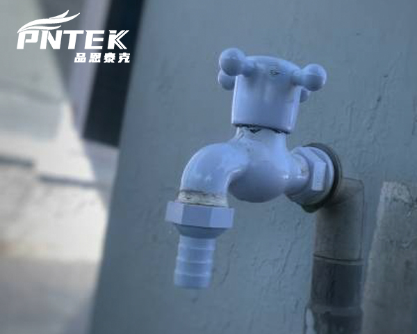 A bib tap conveniently installed on the exterior brick wall of a home