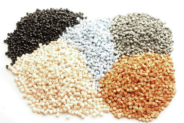 Samples of different colored PVC materials, showing standard white PVC and light gray or tan C-PVC