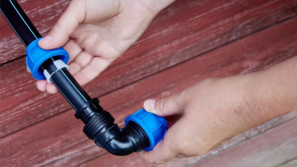 A close-up of a blue or grey PP compression fitting