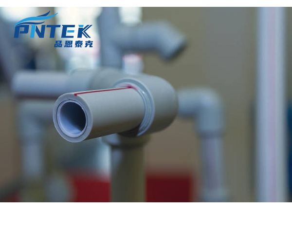 A close-up shot of a heat fusion welding tool connecting a PPR pipe and fitting