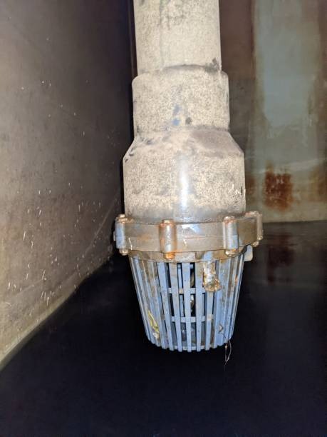 A side-by-side comparison of a white PVC foot valve and a gold-colored brass foot valve