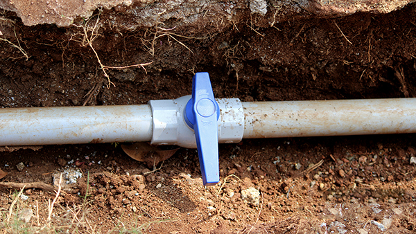 Construction worker installing economical PVC valves in an irrigation system