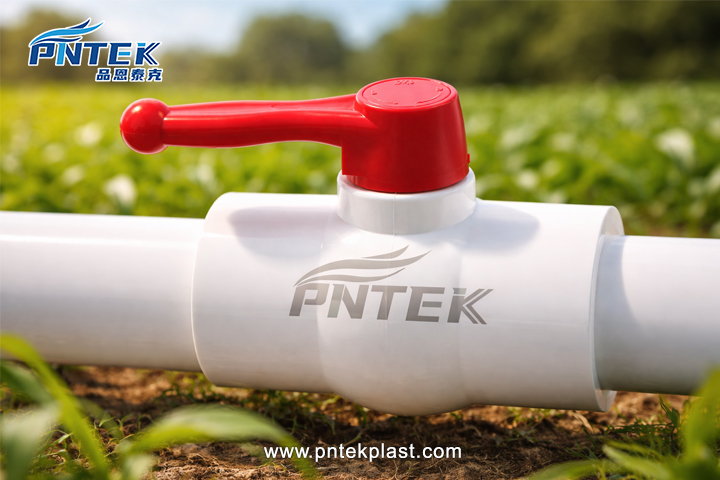 PVC Valves in Agricultural Irrigation A photo of PVC ball valves installed in a sunny agricultural field for irrigation