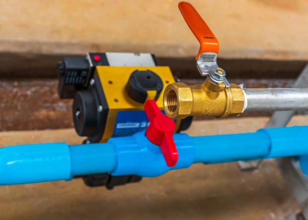 A PVC ball valve and a brass ball valve shown side-by-side for comparison