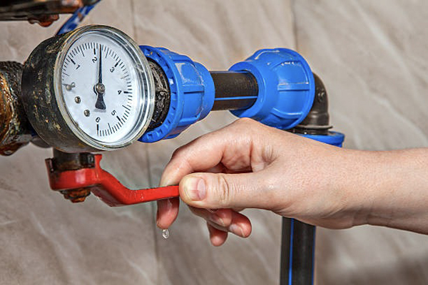 A Pntek PVC valve placed next to a heavy-duty brass ball valve for comparison