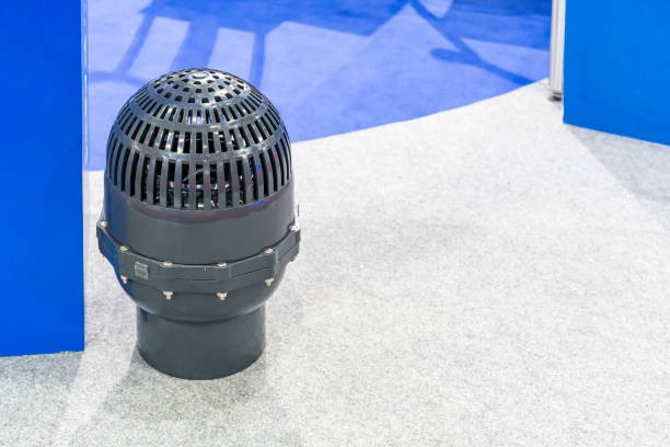 A PVC foot valve submerged at the end of a suction line inside a water tank