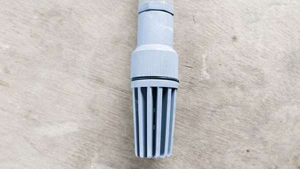 A cutaway view of a spring check valve showing the spring and disc