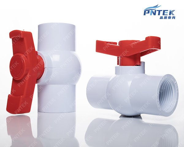 A person gripping a stiff PVC ball valve handle with frustration