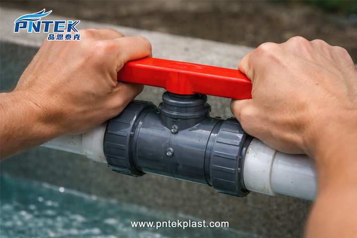 Stuck PVC Ball Valve Handle A frustrated person using two hands to try and turn a stiff PVC ball valve handle