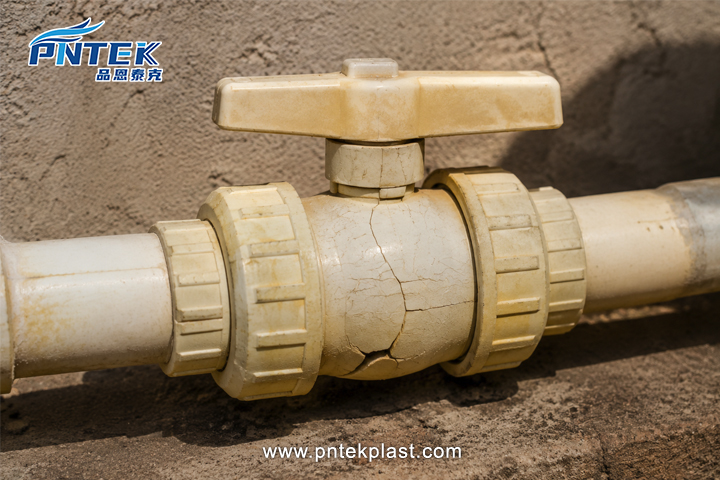 UV Damage on PVC Ball Valve A cracked and yellowed PVC valve that has been damaged by direct sunlight exposure